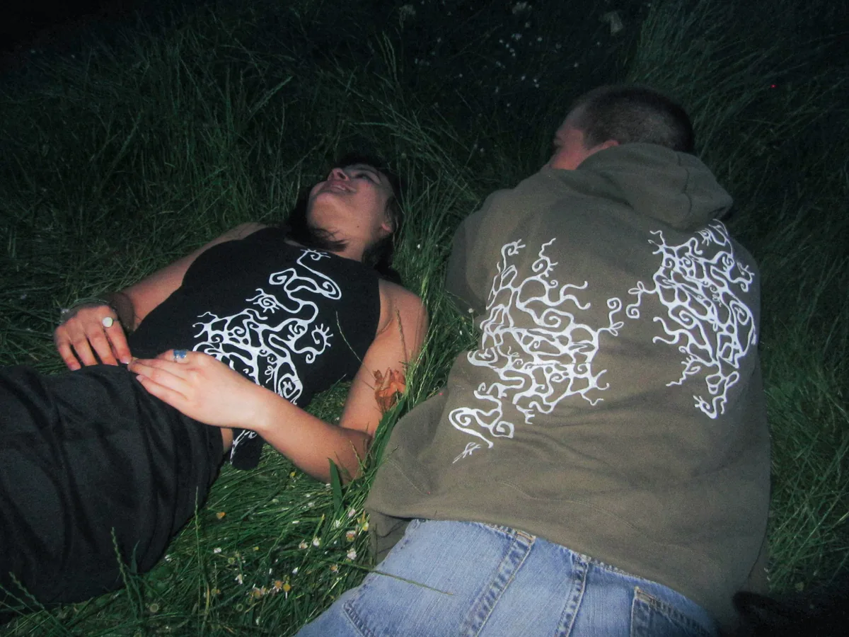 Two people in Tendril apparel in grass